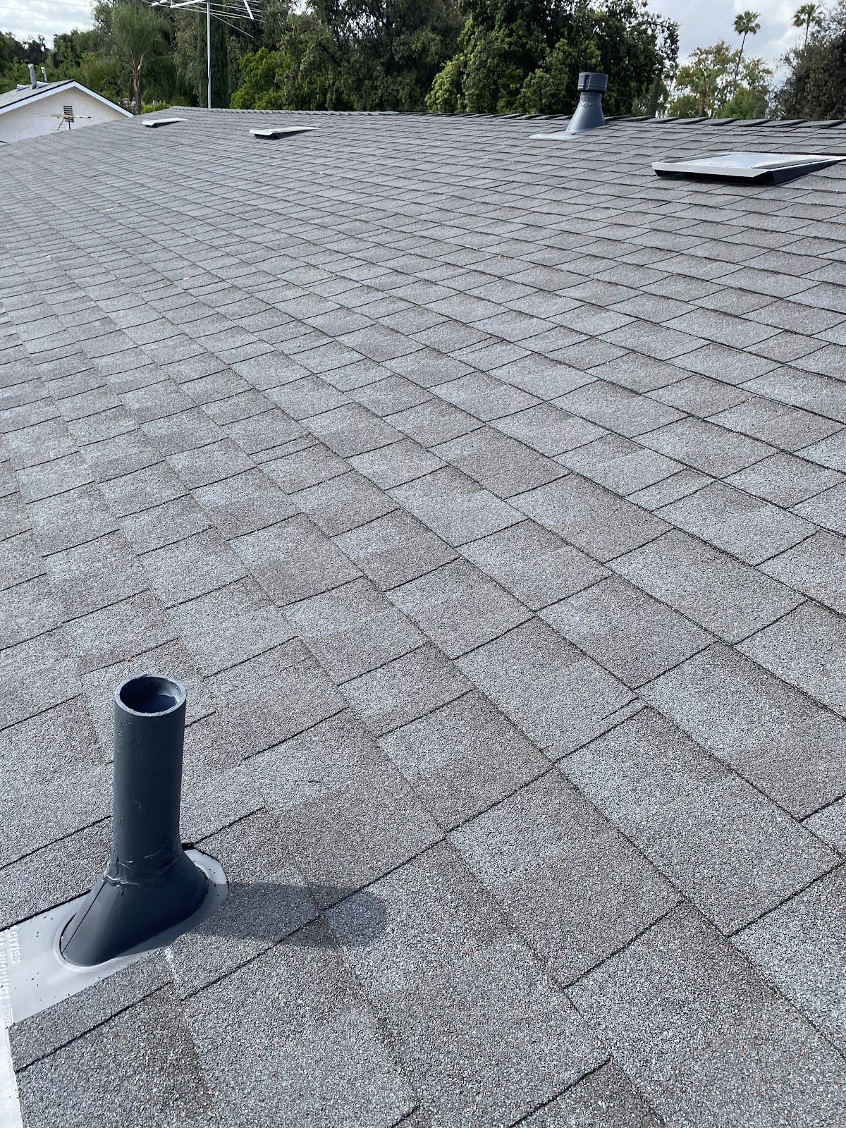 Completed shingle roof with new vent boot